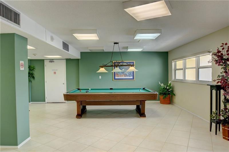 1200 Hibiscus Avenue, Unit 1106 Pompano Beach, FL 33062 - Photo 12 of 19 a room with lots of furniture and windows