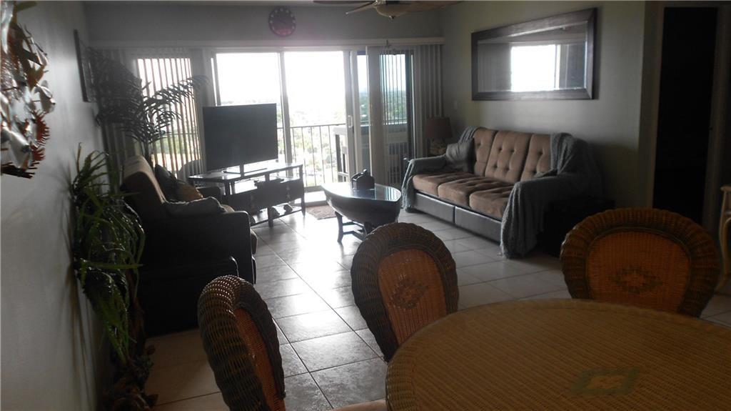 1200 Hibiscus Avenue, Unit 1106 Pompano Beach, FL 33062 - Photo 4 of 19 a living room with furniture and a flat screen tv
