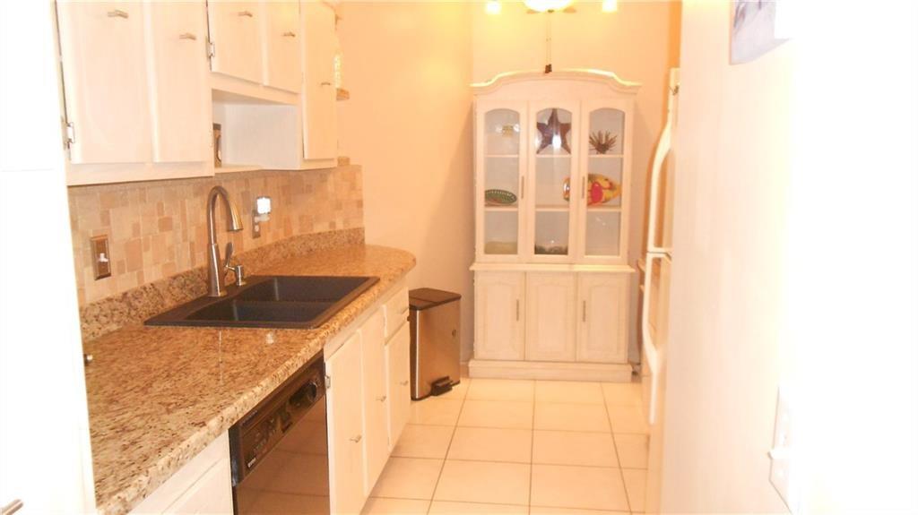 1200 Hibiscus Avenue, Unit 1106 Pompano Beach, FL 33062 - Photo 5 of 19 a kitchen with granite countertop a sink and a granite top