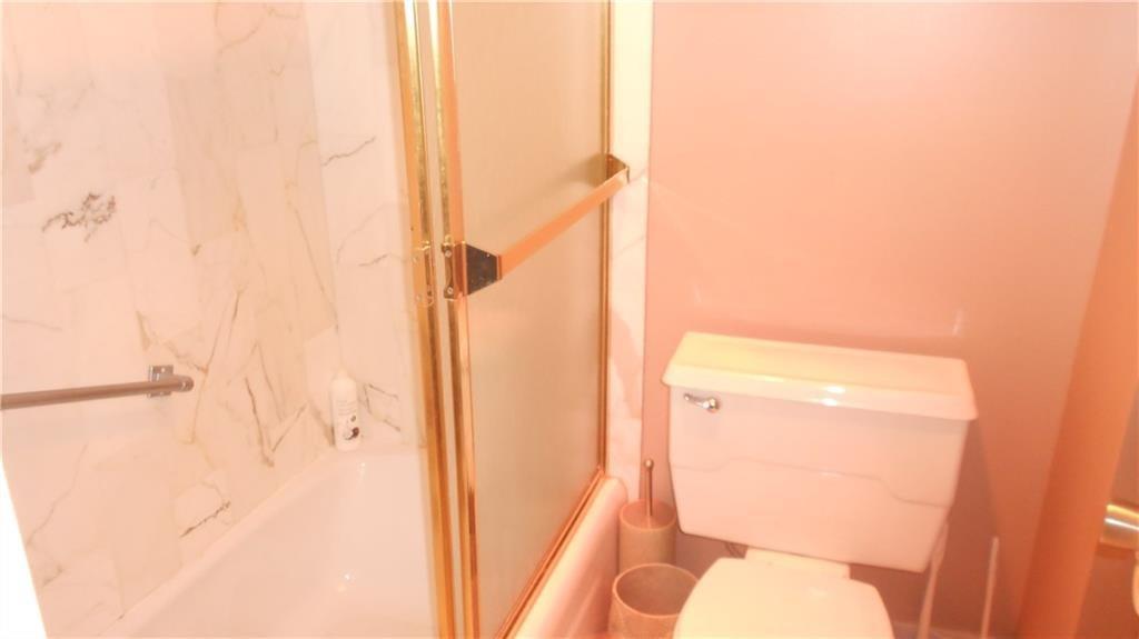 1200 Hibiscus Avenue, Unit 1106 Pompano Beach, FL 33062 - Photo 7 of 19 a bathroom with a toilet and a shower curtain