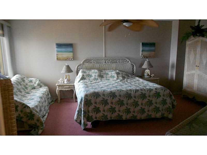 1200 Hibiscus Avenue, Unit 1106 Pompano Beach, FL 33062 - Photo 8 of 19 a living room with furniture and a table