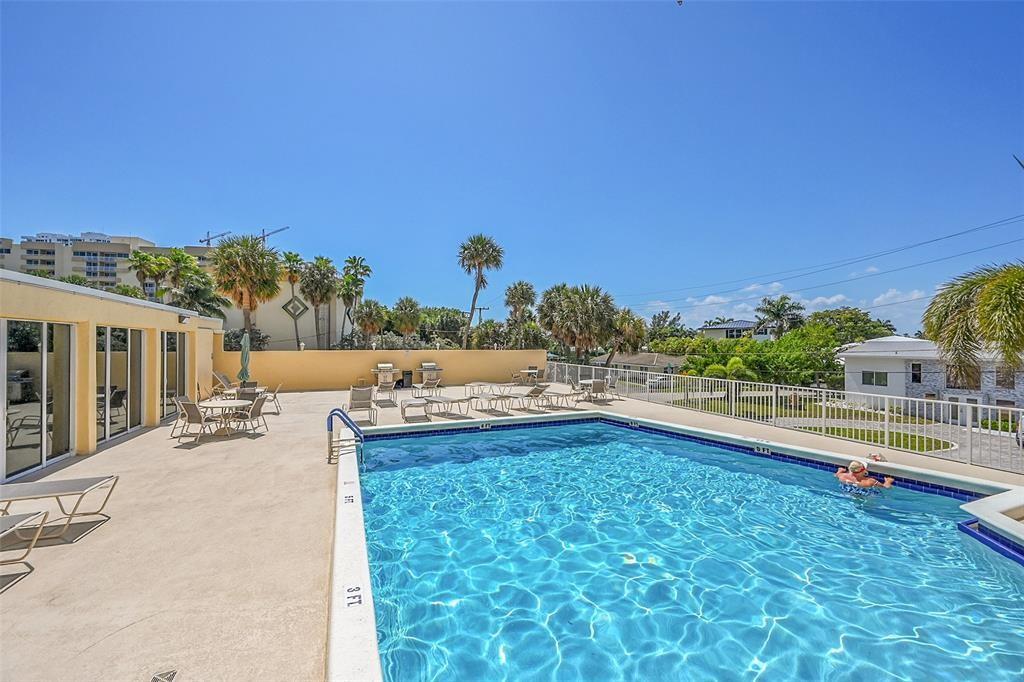 1200 Hibiscus Avenue, Unit 1106 Pompano Beach, FL 33062 - Photo 10 of 19 a view of a swimming pool and an outdoor seating