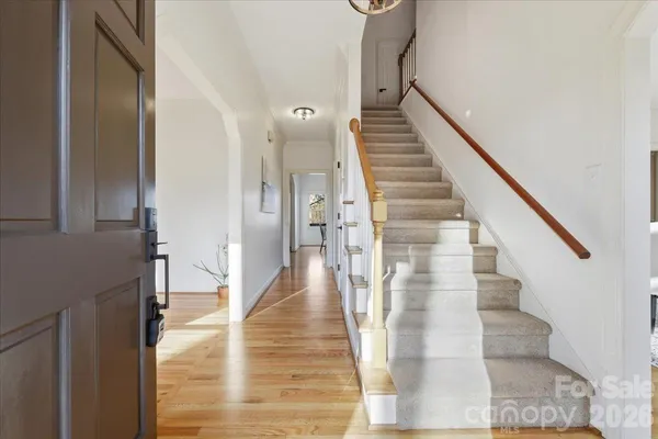 a view of entryway and hall with wooden floor
