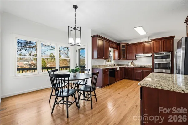 a view of a dining room with furniture window and wooden floor