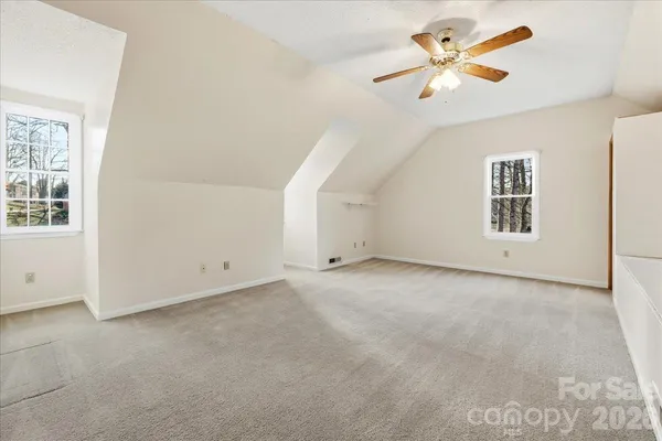 an empty room with a empty space and a ceiling fan