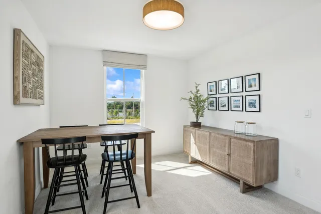 a dining room with furniture and window