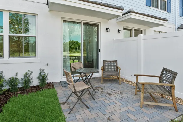 a view of a house with backyard sitting area and garden