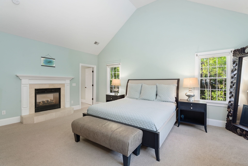 220 Newtown Road Acton, MA 01720 - Photo 16 of 39 a bedroom with a bed and a fireplace