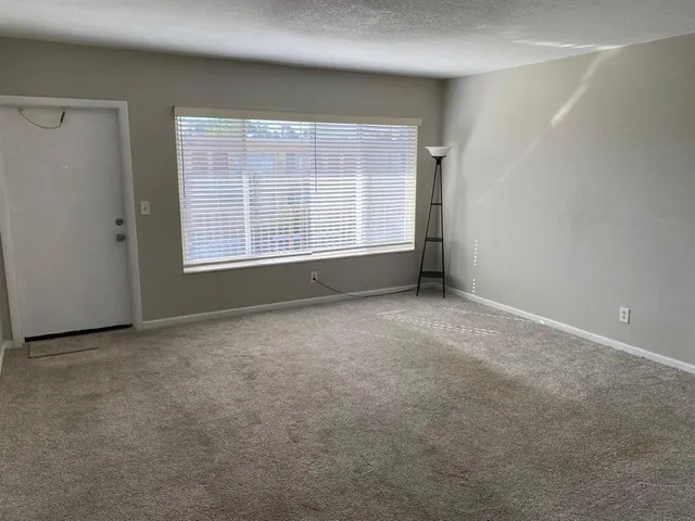 an empty room with a empty space and windows