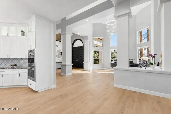 a view of entryway and hall with wooden floor