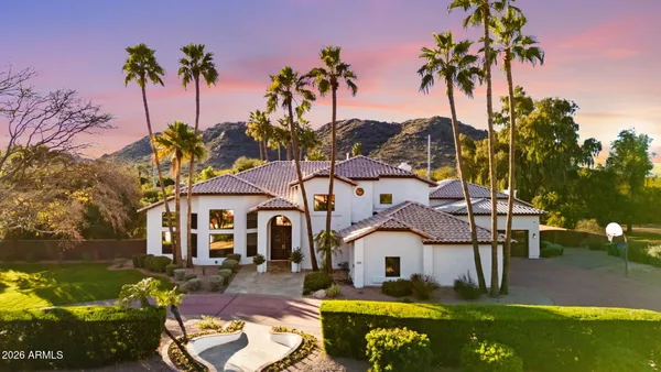 a large kitchen with stainless steel appliances lots of counter space and windows