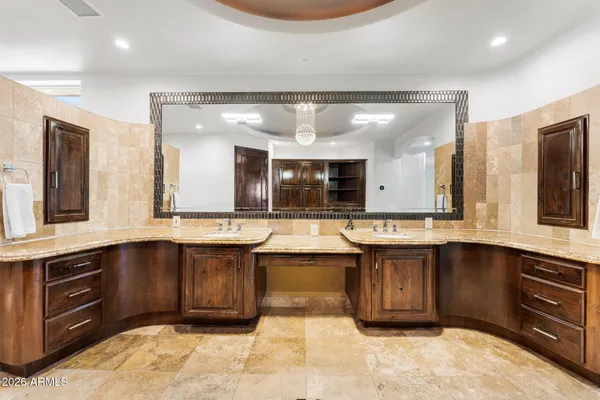a bedroom with bed and a chandelier