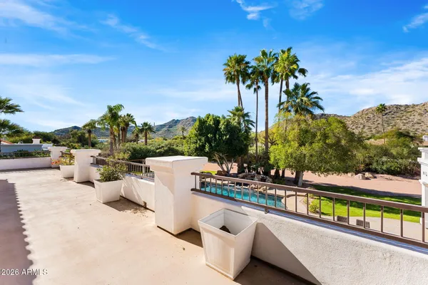 a living room with dining room and wooden floor