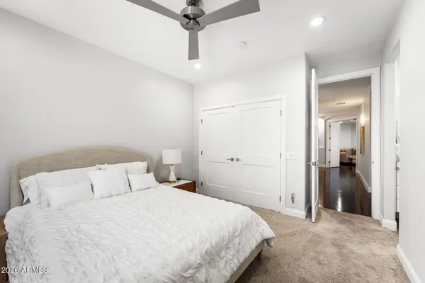 a bedroom with a bed and a chandelier