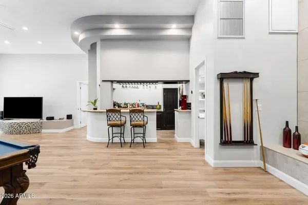 a view of a swimming pool with a lounge chair and palm trees