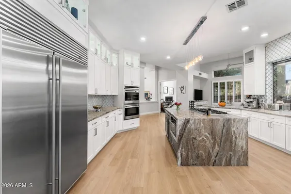 a dining room with furniture a chandelier and window