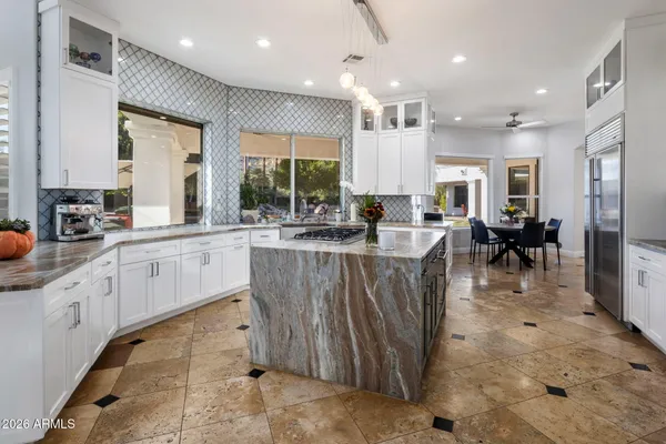 a living room with furniture and floor to ceiling windows