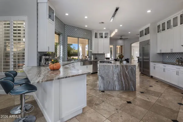 a view of a kitchen with granite countertop lots of counter top space and wooden floor