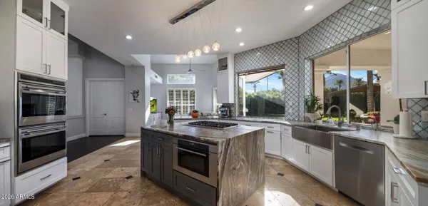 a view of a kitchen with a sink dishwasher and a fireplace