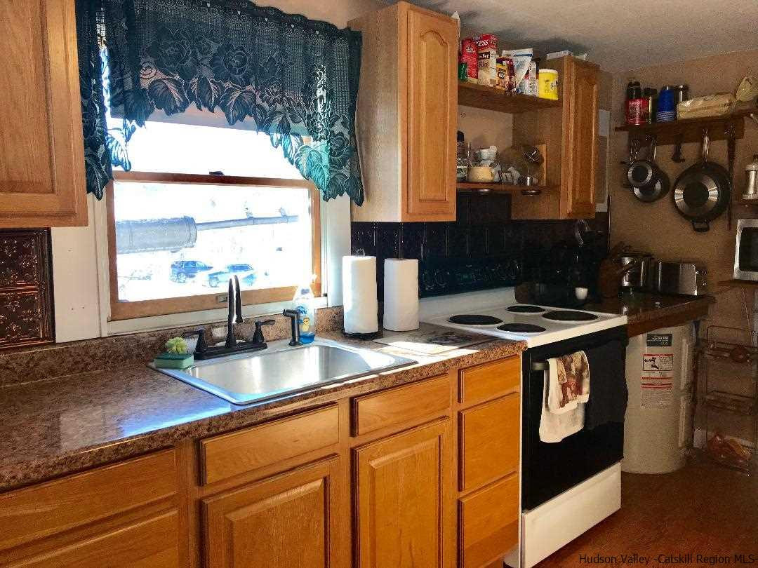 22 Wallkill Avenue Wallkill, NY 12589 - Photo 13 of 26 a kitchen with stainless steel appliances granite countertop a sink stove and cabinets