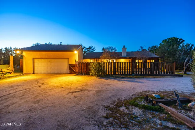 a kitchen with stainless steel appliances granite countertop a sink a refrigerator and a granite counter tops