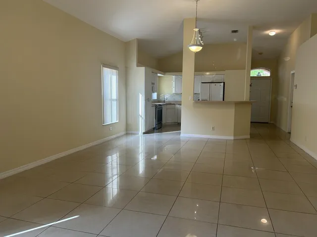 a view of a kitchen with a sink and a window