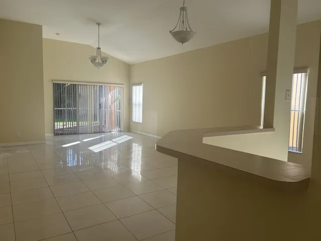 a view of a livingroom with wooden floor and a ceiling fan