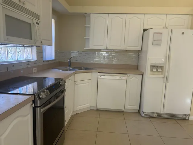 a kitchen with a sink and a refrigerator