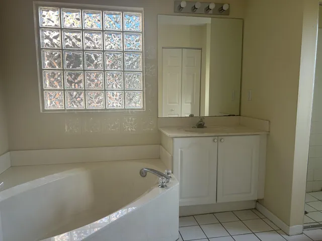 a bathroom with a bathtub and window