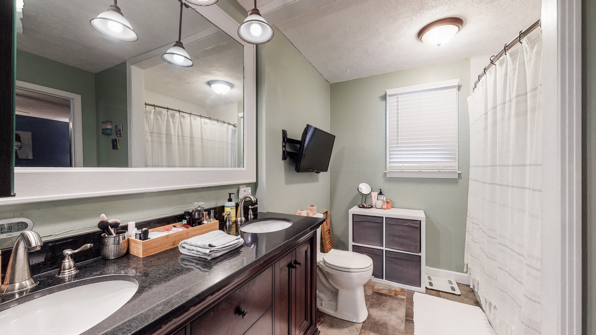 7306 Liberty Road Fairview, TN 37062 - Photo 12 of 19 a bathroom with a granite countertop sink a toilet and mirror