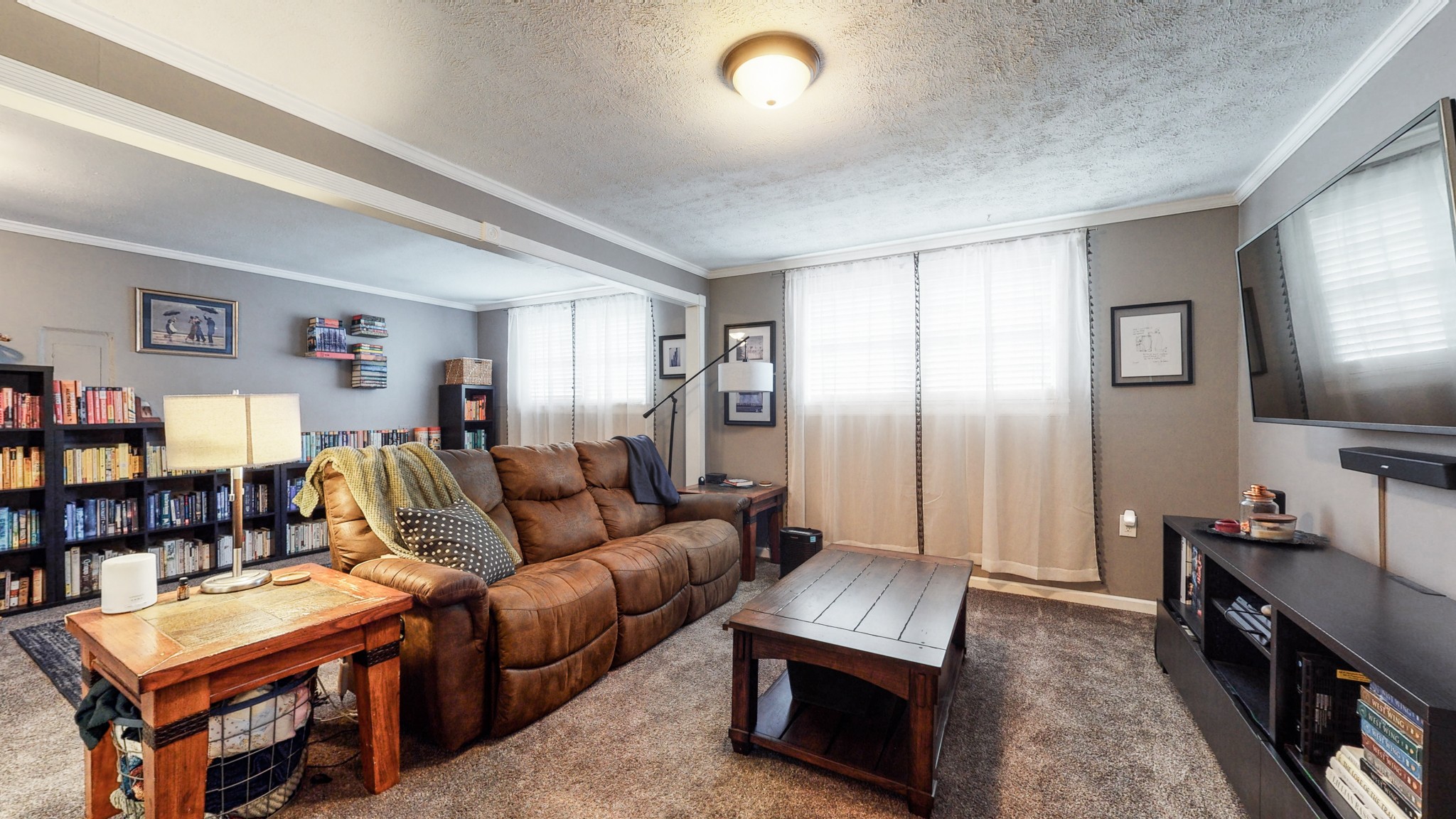 7306 Liberty Road Fairview, TN 37062 - Photo 16 of 19 a living room with furniture a flat screen tv and a refrigerator