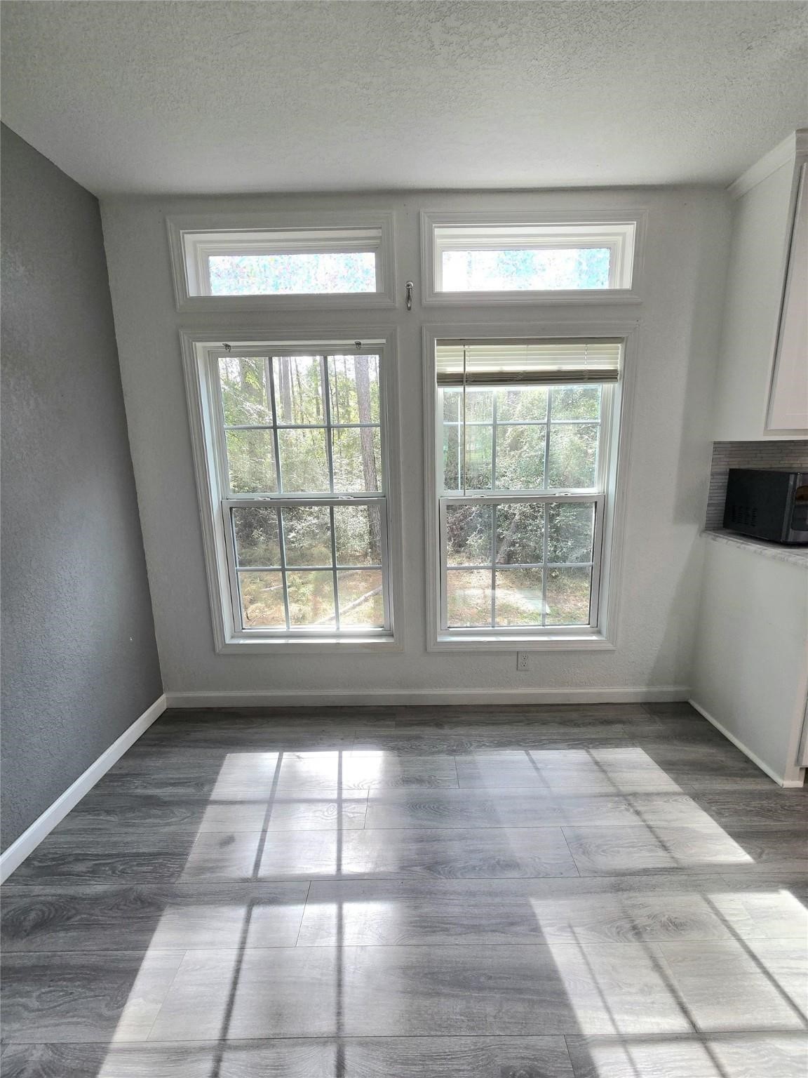 304 North Walnut Drive Trinity, TX 75862 - Photo 6 of 9 a view of empty room with windows and chandelier