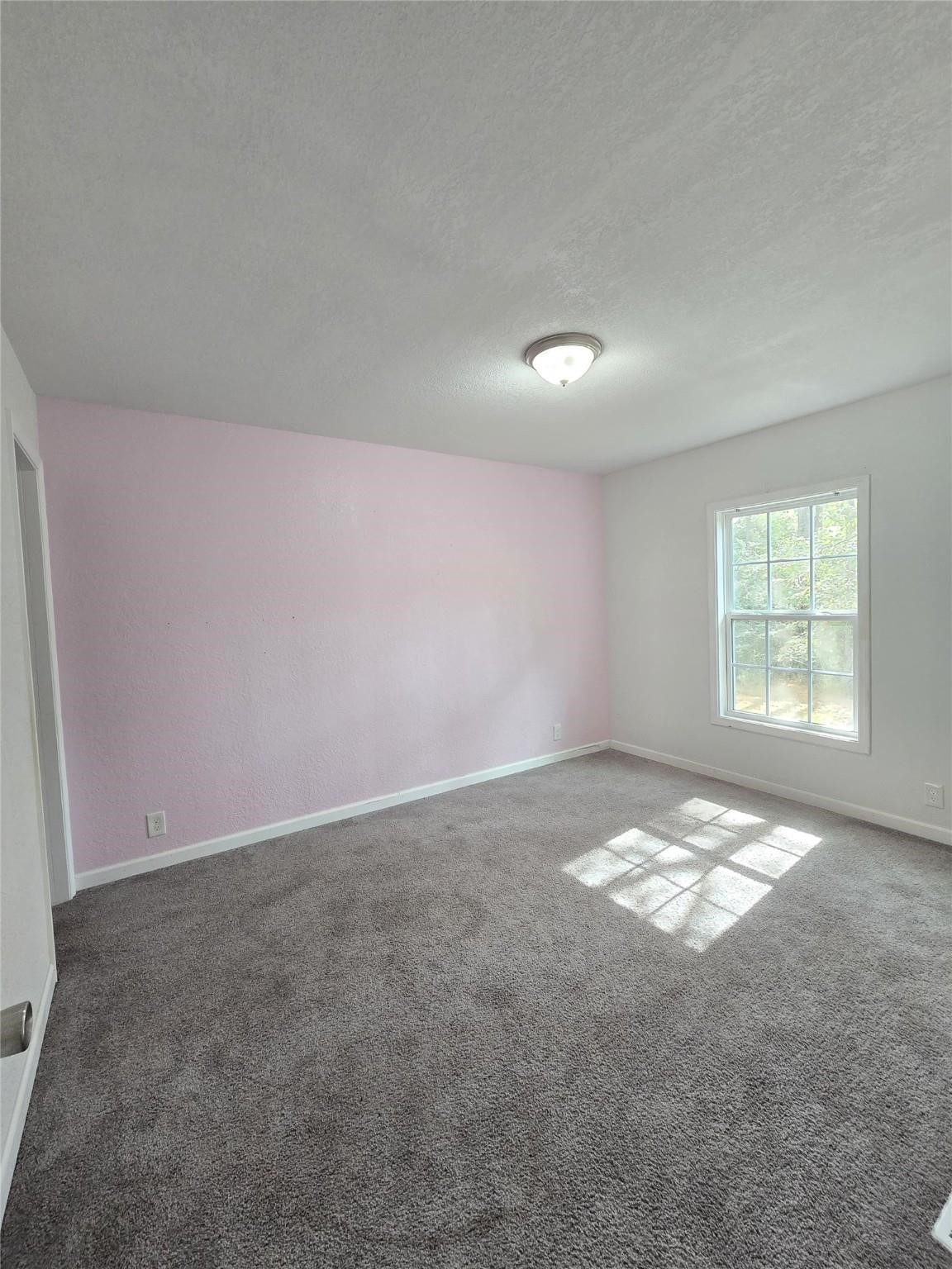 304 North Walnut Drive Trinity, TX 75862 - Photo 8 of 9 an empty room with a empty space and windows