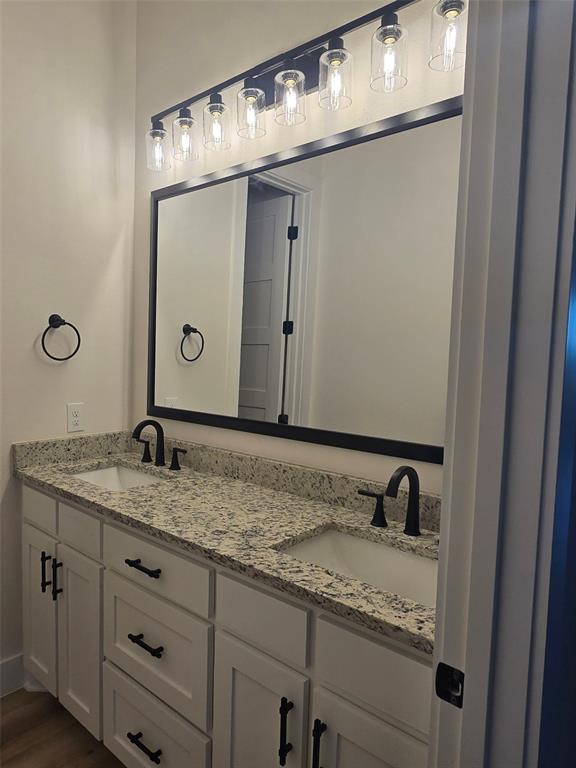 808 N Avenue East Springtown, TX 76082 - Photo 13 of 21 a bathroom with a granite countertop sink and a mirror