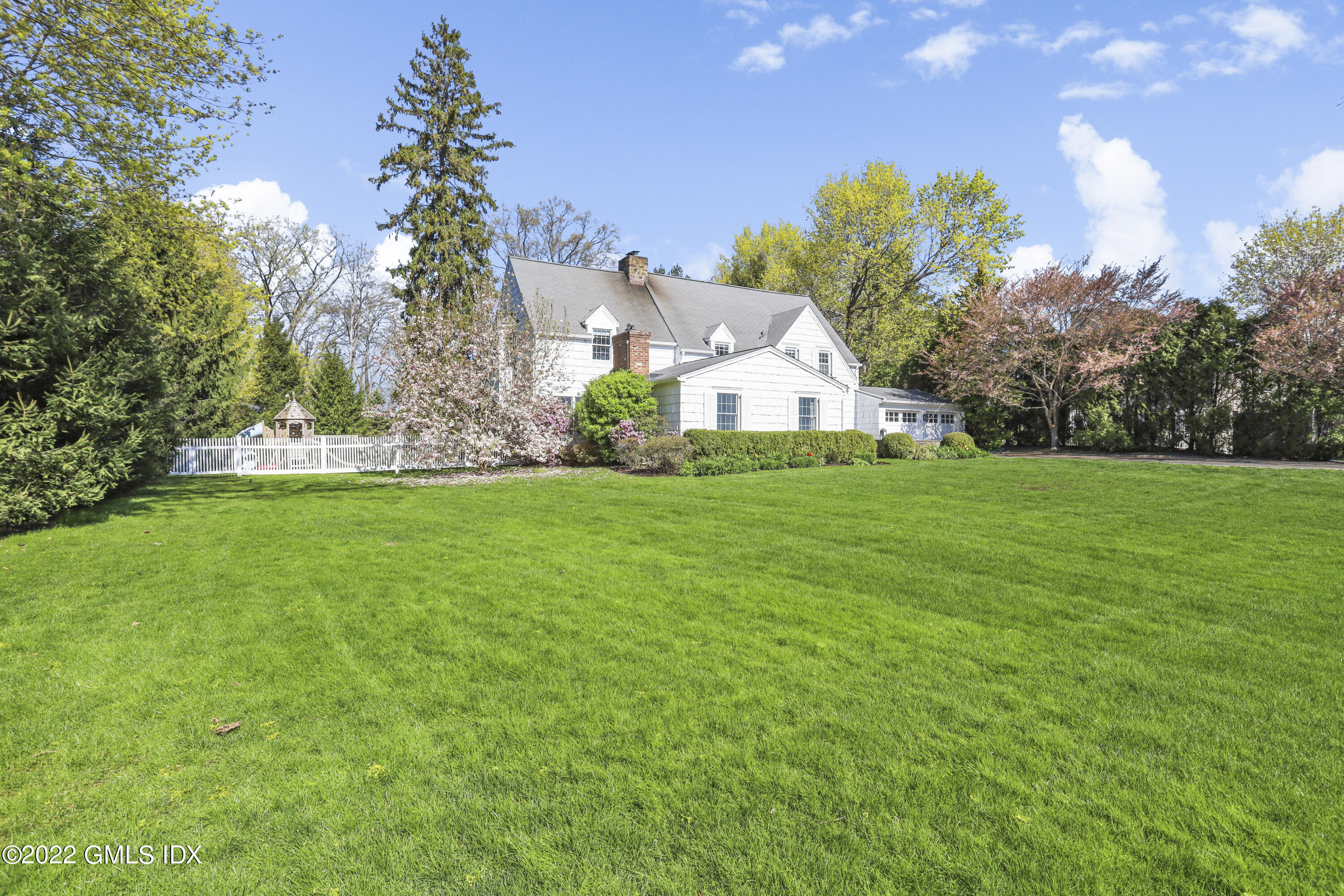 3 Random Road Old Greenwich, CT 06870 - Photo 1 of 1 a white house with a big yard and large trees