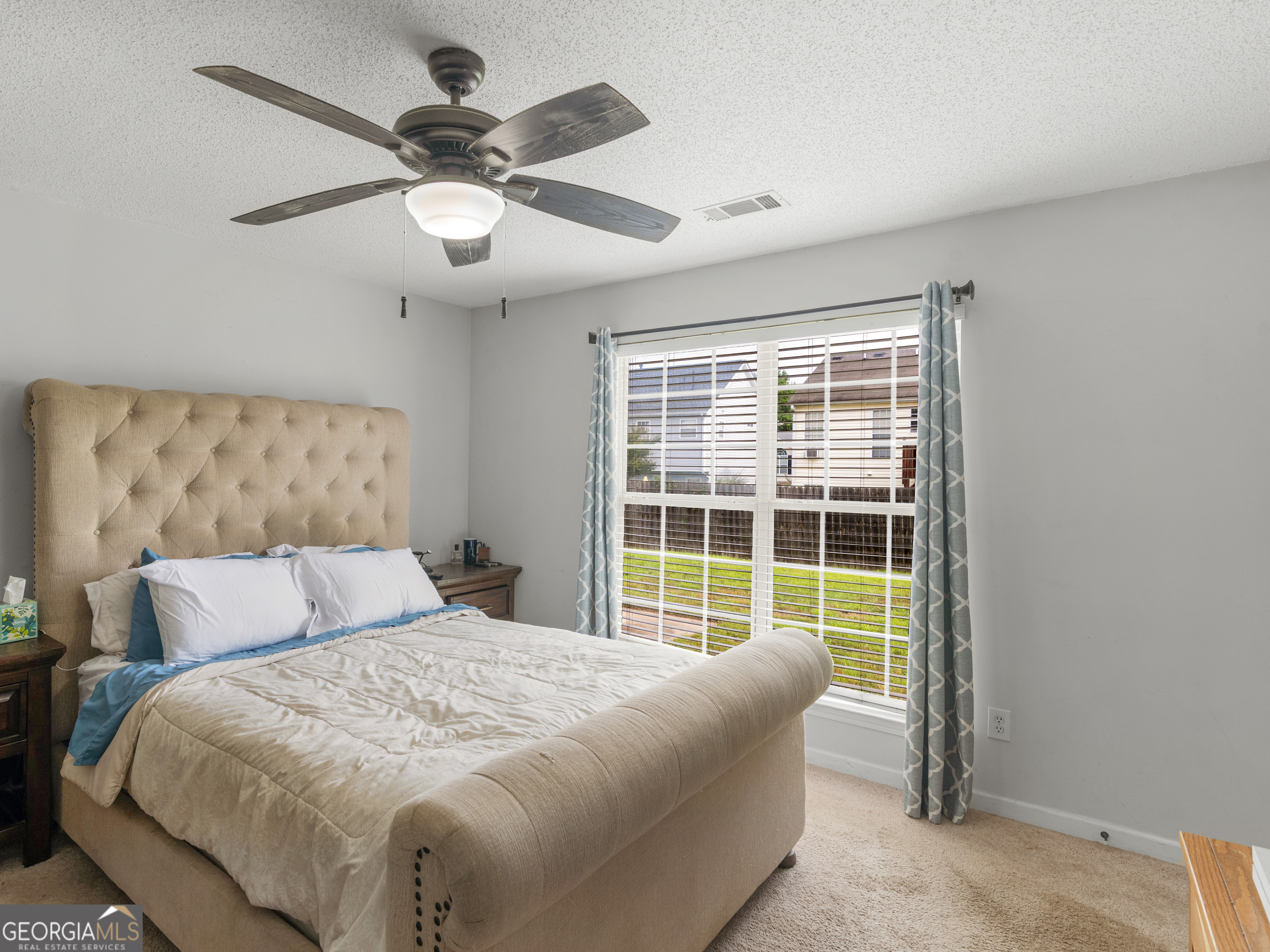 3370 Waggoner Place Rex, GA 30273 - Photo 14 of 25 a bedroom with a large bed and a window