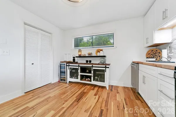 a kitchen with stainless steel appliances a stove and a wooden floors