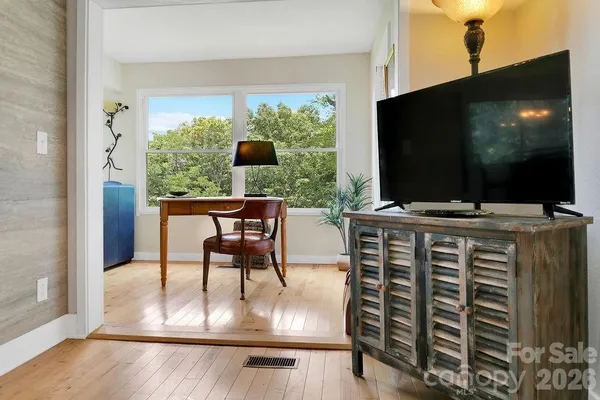 a dining room with furniture and flat screen tv