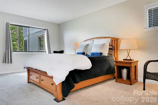 a bed room with a bed and a potted plant