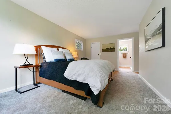 a bed room with a bed and a night stand