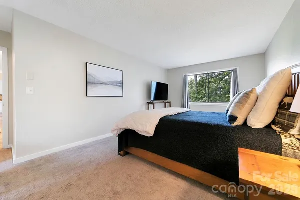 a bedroom with bed and window