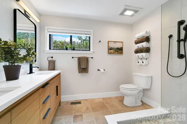 a spacious bathroom with a sink and a mirror