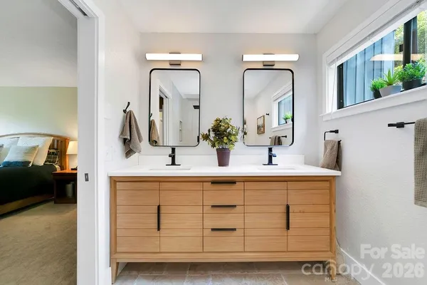 a bathroom with a double vanity sink and a mirror
