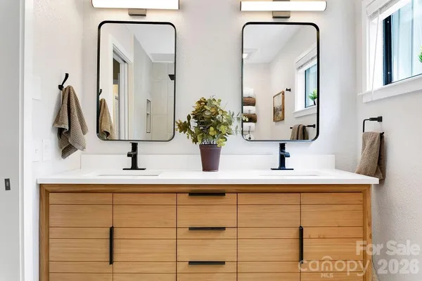 a bathroom with a double vanity sink and a mirror