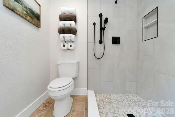 a bathroom with a toilet and a shower