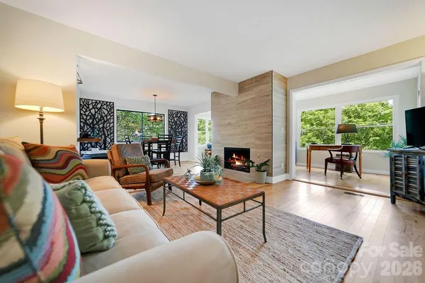 a living room with furniture fireplace and a table