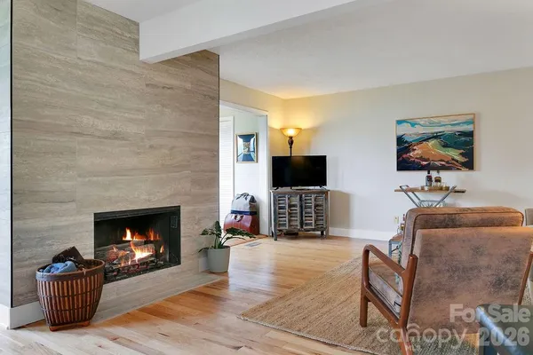 a living room with furniture flat screen tv and a fireplace