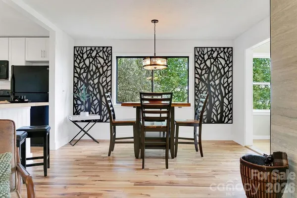 a view of a livingroom with furniture window and wooden floor