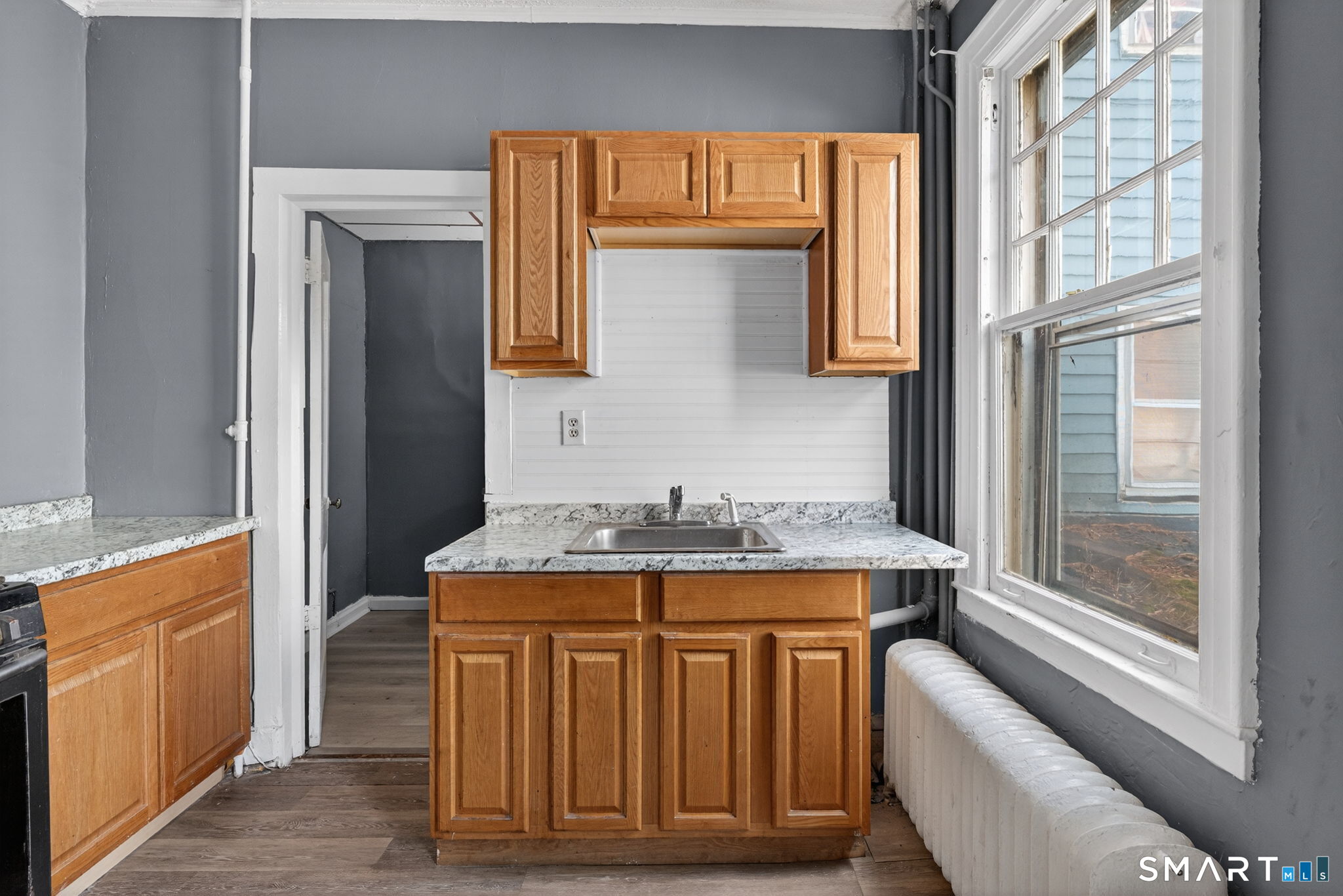 187 Whitney Street, Unit A2 Hartford, CT 06105 - Photo 11 of 17 a bathroom with a granite countertop sink and a mirror