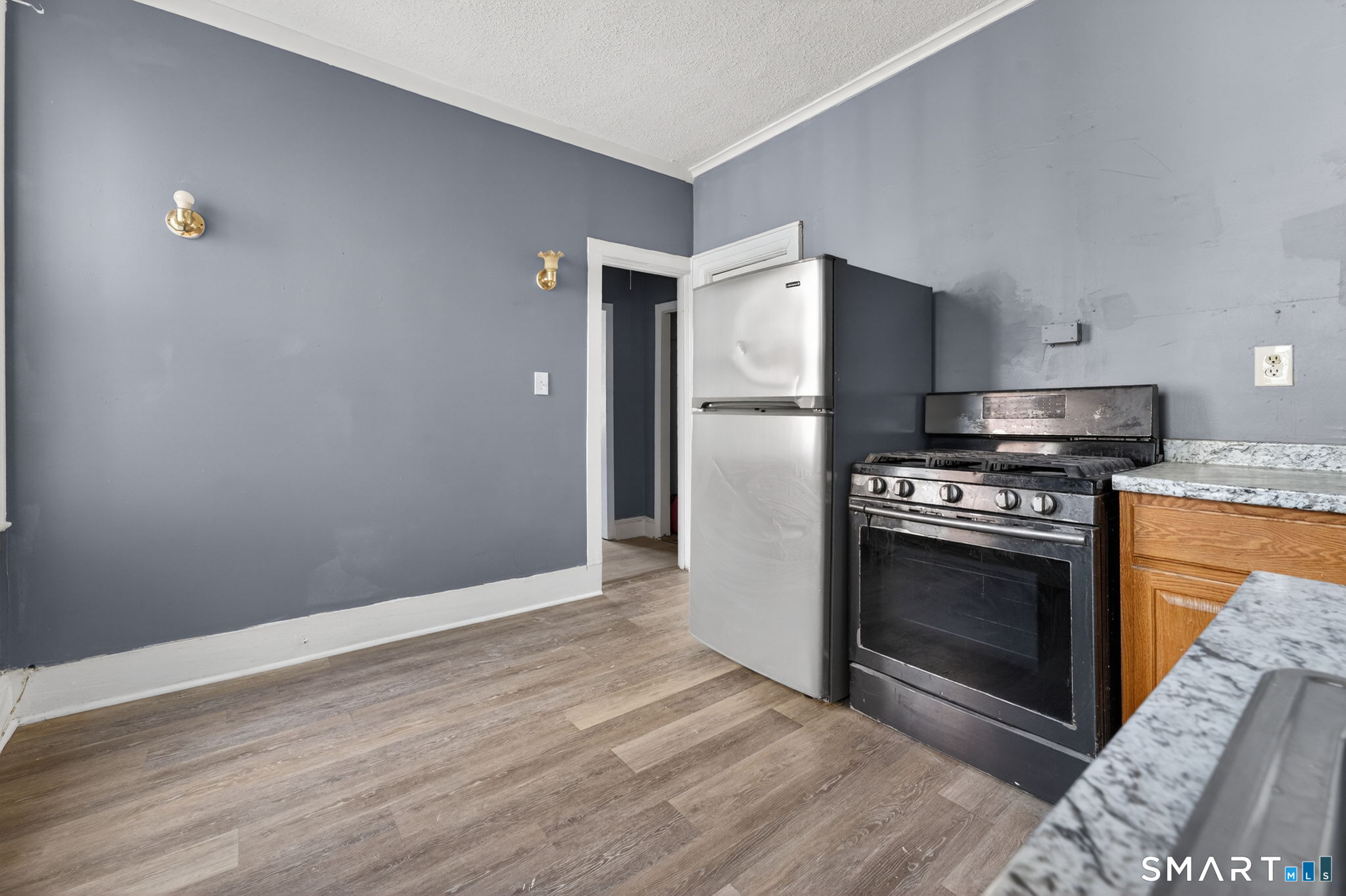 187 Whitney Street, Unit A2 Hartford, CT 06105 - Photo 12 of 17 a kitchen with granite countertop a stove and a refrigerator